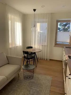 a living room with a couch and a table at Žalio kalno apartamentai in Kaunas