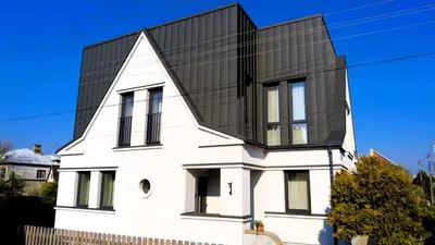 a house with a black roof at Žalio kalno apartamentai in Kaunas
