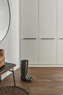 a room with a black boot and white cabinets at IVIS House - Stylish and Original Apartment in Vilnius Old Town in Vilnius