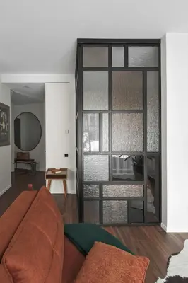a living room with a couch and a window at IVIS House - Stylish and Original Apartment in Vilnius Old Town in Vilnius