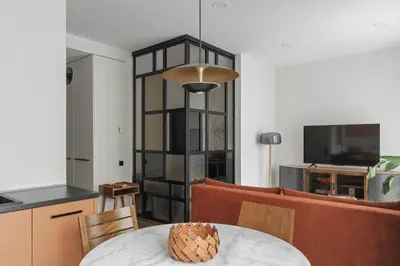 a living room with a dining room table and a kitchen at IVIS House - Stylish and Original Apartment in Vilnius Old Town in Vilnius