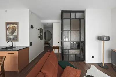 a living room with a couch and a table at IVIS House - Stylish and Original Apartment in Vilnius Old Town in Vilnius