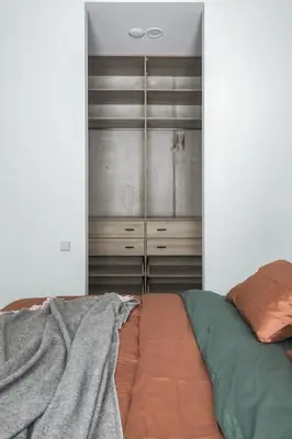 a bedroom with a bed and a closet at IVIS House - Spacious Apartment with Terrace, Vilnius Old Town in Vilnius