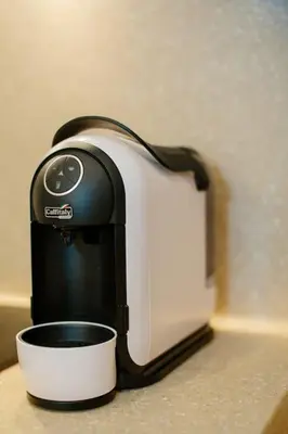 a toaster sitting on a counter next to a cup at Luxury Old Town Apartment in Kaunas