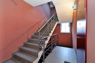 a staircase in a building with red walls at Luxury Old Town Apartment in Kaunas