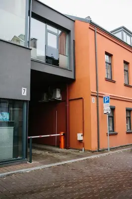 a orange building with a parking sign in front of it at Luxury Old Town Apartment in Kaunas