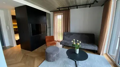 a living room with a couch and a table at J. Ralio apartamentai in Vilnius