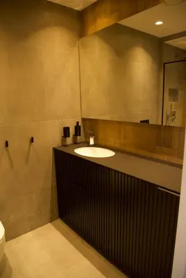 a bathroom with a sink and a mirror at J. Ralio apartamentai in Vilnius