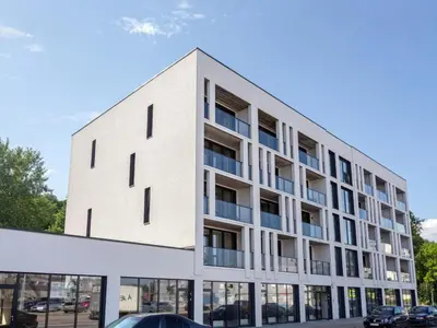 an exterior view of a white building with windows at J. Ralio apartamentai in Vilnius