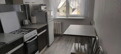 a kitchen with a stove and a table in it at Pas Olia 2 in Zarasai
