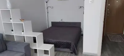 a bedroom with a bed and a white book shelf at Pas Olia 2 in Zarasai