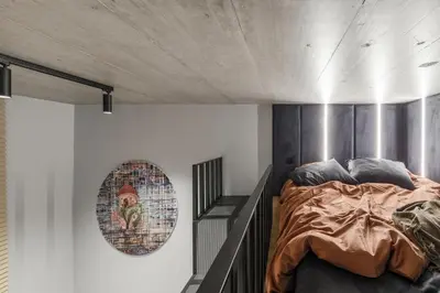 a bedroom with a bed and a poster on the wall at IVIS House Modern Apartment in Vilnius Old Town with balcony in Vilnius