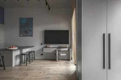 a living room with a desk and a tv on a wall at IVIS House Modern Apartment in Vilnius Old Town with balcony in Vilnius