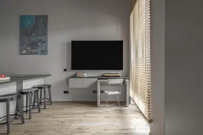 a living room with a tv and a desk with a chair at IVIS House Modern Apartment in Vilnius Old Town with balcony in Vilnius