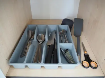 a blue tray with utensils in a box at Sunny apartment with lake and forest view in Visaginas