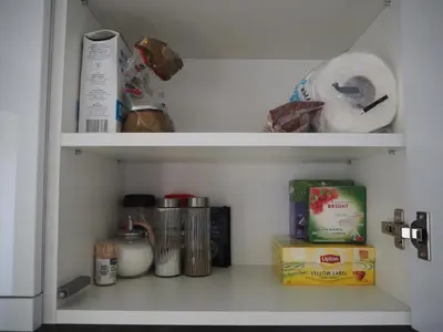 a shelf in a refrigerator filled with food at Sunny apartment with lake and forest view in Visaginas