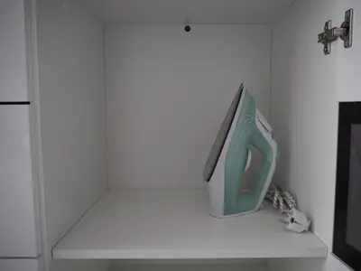 a appliance sitting on a shelf in a kitchen at Sunny apartment with lake and forest view in Visaginas