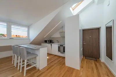 a kitchen with a table and chairs in a room at White 1 BD Old Town Apartment by Hostlovers in Kaunas