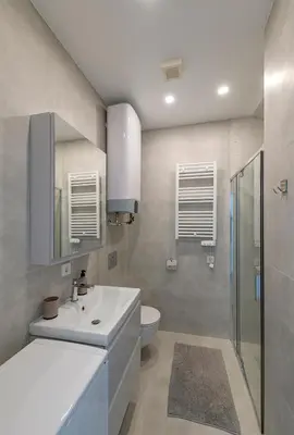 a bathroom with a white sink and a toilet at White 1 BD Old Town Apartment by Hostlovers in Kaunas