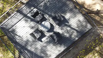 an overhead view of a bird cage with benches at Premium Forest Bungalow with HOT TUB in Ažuluokesa
