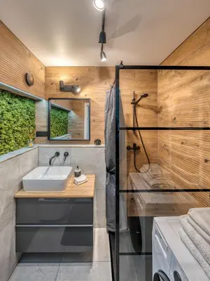 a bathroom with a sink and a shower at Cozy Apartment with panoramic view in Anykščiai
