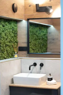 a bathroom with a sink and a mirror at Cozy Apartment with panoramic view in Anykščiai