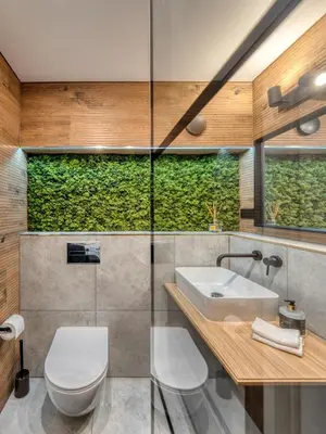a bathroom with a toilet and a sink at Cozy Apartment with panoramic view in Anykščiai