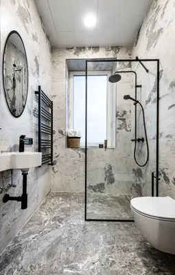 a bathroom with a glass shower and a sink at Oldtown Trinity House in Kaunas