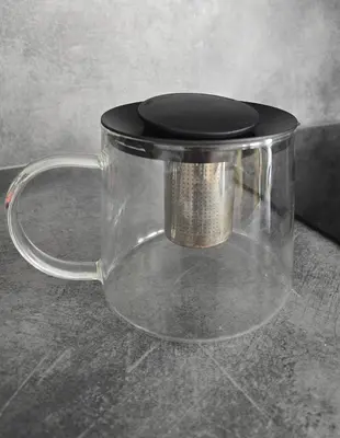 a glass mug with a black top on a table at Oldtown Trinity House in Kaunas