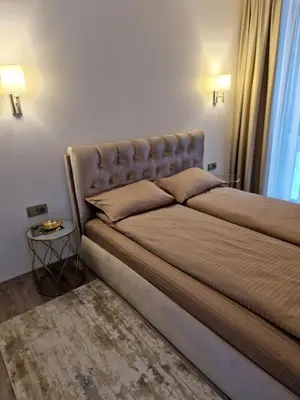 a large bed in a room with a table at Life Story in Kaunas