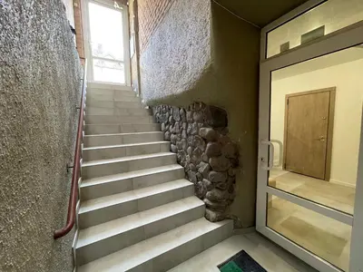 a staircase leading to a door in a building at Modern guest house in city center I Room 2 in Vilnius