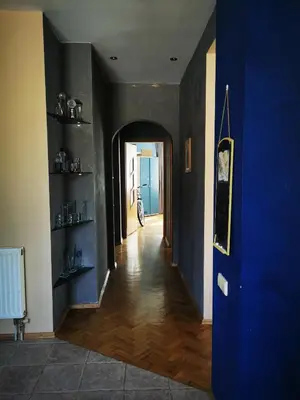 a hallway of a house with a blue wall at Spacious Apartment with free parking in Kaunas in Kaunas