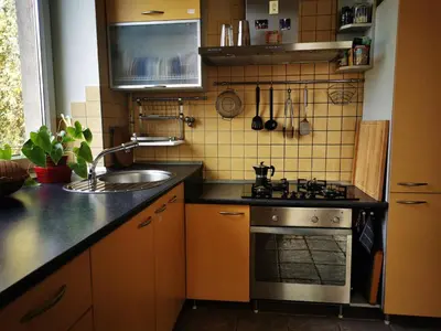 a kitchen with a sink and a stove at Spacious Apartment with free parking in Kaunas in Kaunas