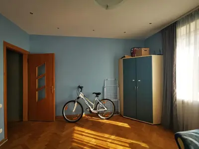 a bike parked in a room with a blue wall at Spacious Apartment with free parking in Kaunas in Kaunas