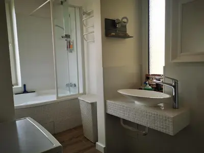 a bathroom with a sink and a shower at Spacious Apartment with free parking in Kaunas in Kaunas