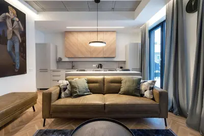 a living room with a couch and a kitchen at Renaissance Key Apartment 29 in Vilnius
