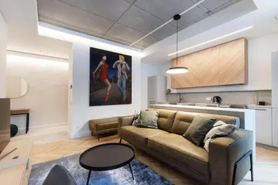 a living room with a couch and a painting on the wall at Renaissance Key Apartment 29 in Vilnius