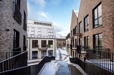 an alley between two buildings with snow on the ground at Renaissance Key Apartment 29 in Vilnius