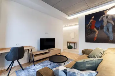 a living room with a couch and a flat screen tv at Renaissance Key Apartment 29 in Vilnius