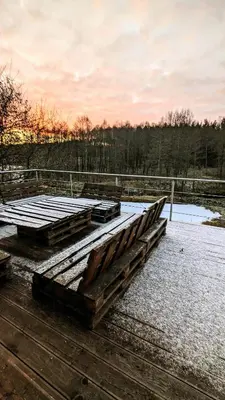 a pile of wood sitting on top of a dock at Baltamiškio slėnis in Baltamiškis