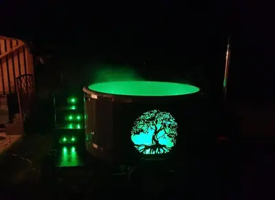 a barrel with a tree on it with green lights at Baltamiškio slėnis in Baltamiškis