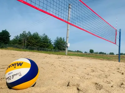 a volleyball ball sitting in front of a net at Baltamiškio slėnis in Baltamiškis
