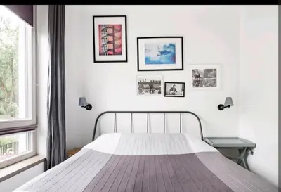 a white bedroom with a bed and a window at Free Indoor Parking Old Town Basanavičius Park & Balcony in Vilnius