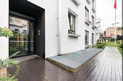 an open door of a white building with a brick sidewalk at Free Indoor Parking Old Town Basanavičius Park & Balcony in Vilnius