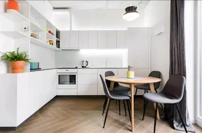 a small kitchen with a table and chairs at Free Indoor Parking Old Town Basanavičius Park & Balcony in Vilnius