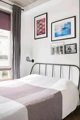 a bedroom with a bed and two pictures on the wall at Free Indoor Parking Old Town Basanavičius Park & Balcony in Vilnius