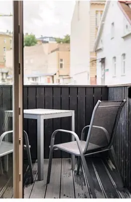 a patio with a table and chairs on a balcony at Free Indoor Parking Old Town Basanavičius Park & Balcony in Vilnius