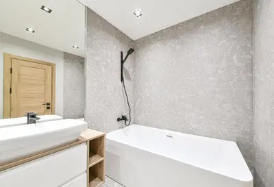 a bathroom with a white tub and a sink at Apartments in Vilnius in Vilnius