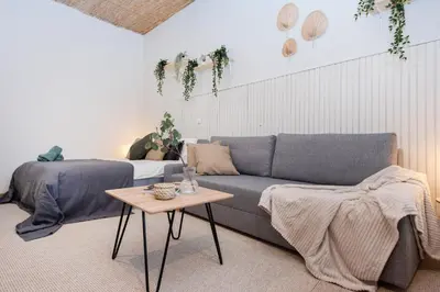 a living room with a couch and a table at Bali house Vilnius in Vilnius
