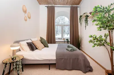 a bedroom with a bed with pillows and a window at Bali house Vilnius in Vilnius